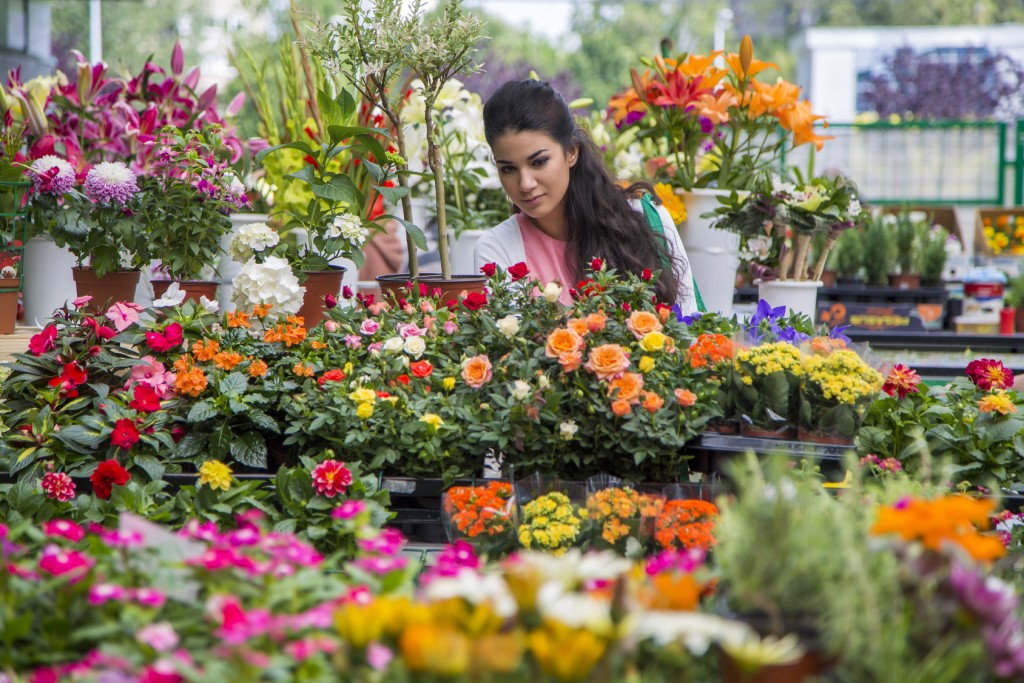 Young woman buying flowers