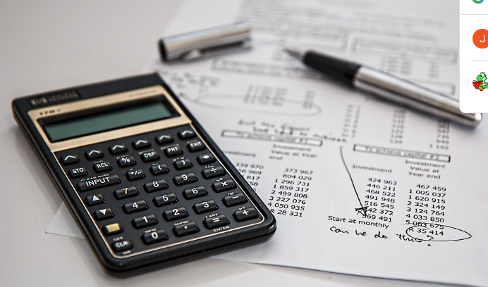 Notes and a calculator for tracking business expenses.